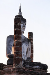 A Buddha statue at Wat Mahathat Temple in the precinct of Sukhothai Historical Park. UNESCO World Heritage Site in Thailand.
