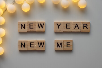 New year new you sign with garland white background. Top view.