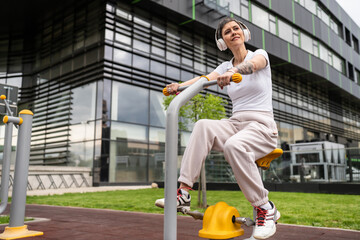One woman modern mature caucasian female with short hair training in front of building in day on...