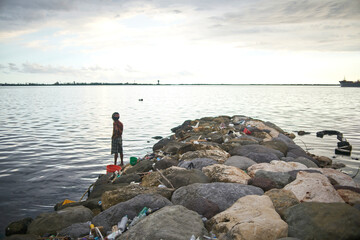 Man with fishing line at the seashore