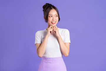 Portrait of a beautiful Asian woman posing on a purple background