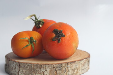 three tomatoes on a white background