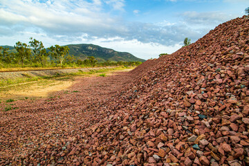 Gravel pile with mountain in background