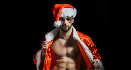 Christmas sexy santa. Young men in santa hat strip for adults. Muscle man at xmas. Santa with...
