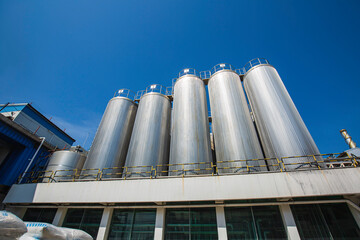 Stainless vertical steel tanks with equipment tank chemical cellar at the with stainless steel