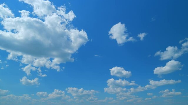 Puffy fluffy white clouds. Forming cloud moving with blue sunny, summer skies. Time lapse.