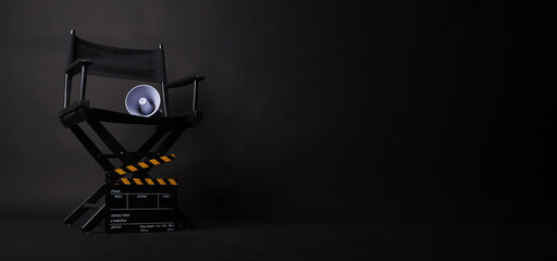 Director chair and Clapper board and megaphone on black blackground.