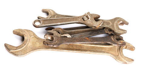 A lot of wrenches of different sizes lie in a pile on a white background. Wrenches isolated on white background.