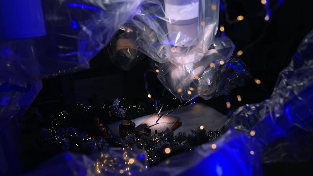 Mechanical hand writing with pen. Modern robot drawing new year letter.