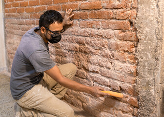 Construction mason working on a brick wall