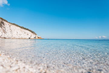 Fototapeta na wymiar Beautiful view of the blue clear sea with beach and rocks on Elba island, Italy