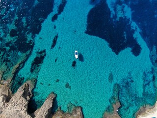 Yacht anchored in crystal clear waters of a beach of Majorca. Amazing turquoise view of the...
