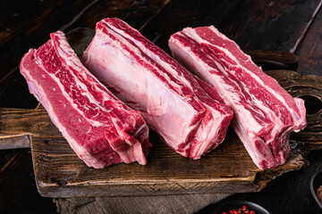 Raw Organic Beef Short Ribs, on old dark  wooden table background