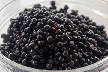 blueberries in a large glass bowl on a white table background