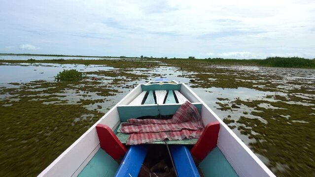 Fishing boat in a lake water in the morning,Old wooden fishing boat, wooden fishing boat in a lake water Beautiful landscape nature view in Thale noi Phatthalung Thailand