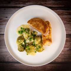 Recipe for homemade chicken fillet cordon bleu style with Brussels sprouts. High quality photo