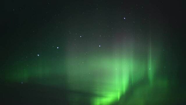 Northern Lights (Aurora Borealis) lighting up the night sky. Time Lapse. 