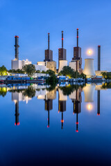 A power station in Berlin during blue hour reflected in a canal