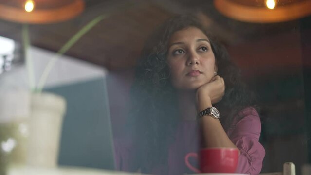 Tired sad upset female face exhausted dissatisfied Indian woman manager worker girl looking at laptop with bored tries to work in morning in office read bad news boring working routine laziness.