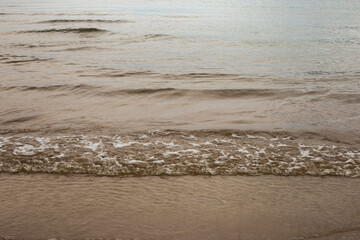 Soft wave of sea on sandy beach.