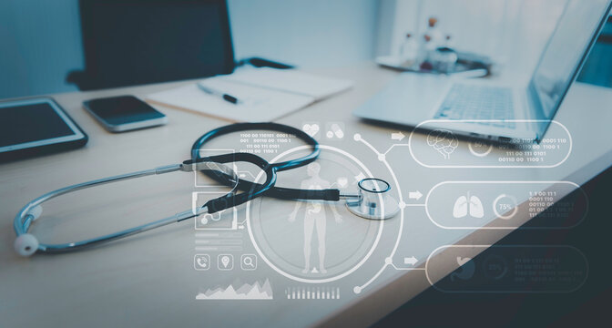 Stethoscope with computer laptop on doctor desk at hospital clinic with hologram futuristic graphic, Digital healthcare technology concept