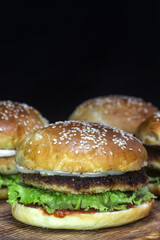Homemade burgers with chicken cutlet, lettuce, pickled onions, mayonnaise and ketchup.