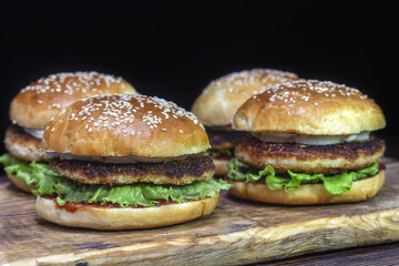 Homemade burgers with chicken cutlet, lettuce, pickled onions, mayonnaise and ketchup.