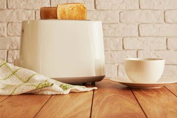 Fresh breakfast on the kitchen. Bread from toaster and coffee cup. Cooking and homeware technologies backgrounds - obrazy, fototapety, plakaty