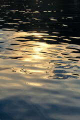 Sunset sun reflection on a wavy sea water. Abstract nature backgrounds