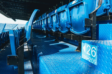 Numbers rows of seats sign installed on stair in stadium.	