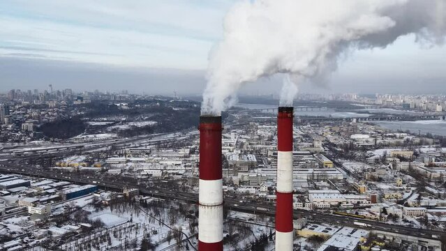 Aerial view of the heat power plant. Pipes with smoke and emissions into the atmosphere. Ecology and greenhouse effect.