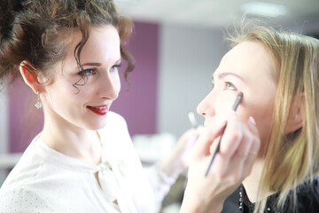 Young girl with a make-up artist