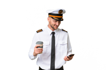 Airplane pilot man over isolated background holding coffee to take away and a mobile