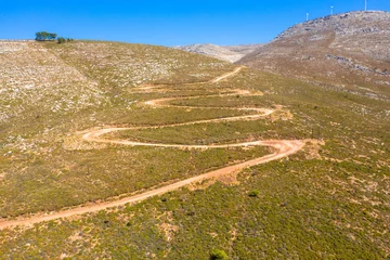 Foto auf Alu-Dibond Spectacular aerial view with serpentine off-road track to top of Attavyros mountain. Highest mountain  in Rhodes island, Greece. Tourism and vacations concept. © familie-eisenlohr.de