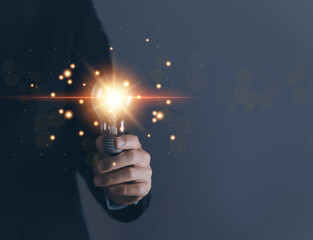 businessman holding a light bulb Digital technology. imagine an idea Creative and innovative.	
