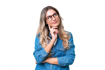 Young Uruguayan woman over isolated background thinking an idea while looking up