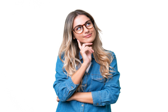 Young Uruguayan woman over isolated background thinking an idea while looking up