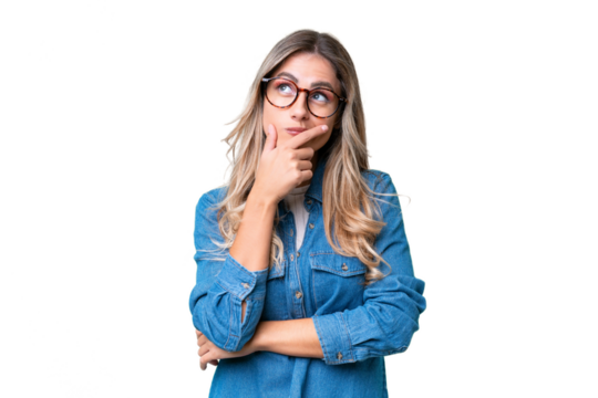 Young Uruguayan woman over isolated background having doubts and with confuse face expression