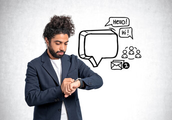 Middle eastern businessman using smart watch, empty text bubble and doodle