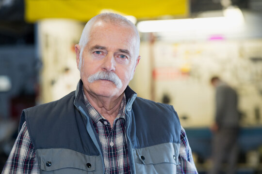elderly mechanic with a sad face