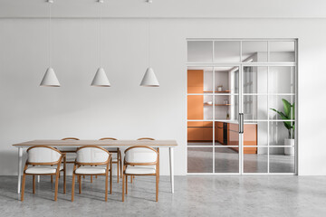 Light living room interior with table and seats, glass doors and kitchen room