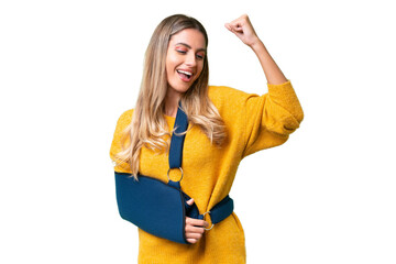 Young Uruguayan woman with broken arm and wearing a sling over isolated background celebrating a...