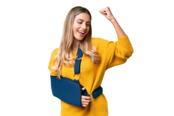 Young Uruguayan woman with broken arm and wearing a sling over isolated background celebrating a victory