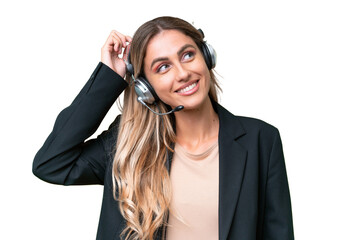 Telemarketer pretty Uruguayan woman working with a headset over isolated background having doubts...
