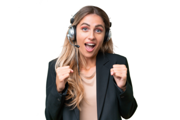 Telemarketer pretty Uruguayan woman working with a headset over isolated background celebrating a victory in winner position