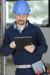 builder with tablet in construction site