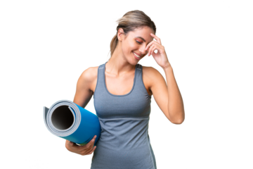 Pretty Young Uruguayan sport woman going to yoga classes while holding a mat over isolated background laughing