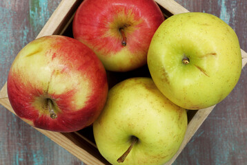 organic ripe apples in a wooden box