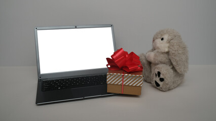 Hare, rabbit , gift boxes and laptop.