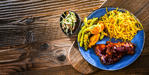 Chicken thighs in tamarind sauce with fried noodles and veggies